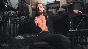 Jay White seated backstage in a black hoodie, pointing at the camera during his AEW promo introducing The Cut