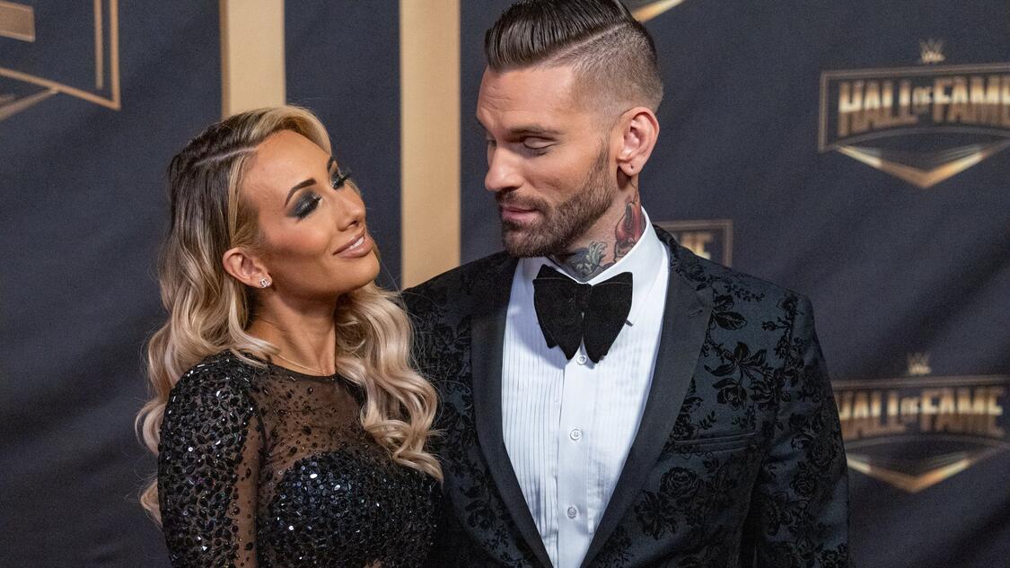 Carmella and Corey Graves smiling at each other on the WWE Hall of Fame red carpet