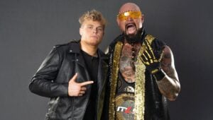 CJ Gallows and Doc Gallows pose together in a studio portrait, with Doc holding an MLW championship belt