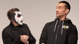 Danhausen in black and white face paint standing beside CM Punk in an AEW hoodie