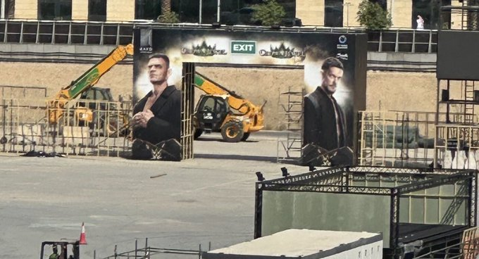 GUNTHER and Finn Balor promotional artwork at a gate of Riyadh Season Stadium ahead of WWE Crown Jewel