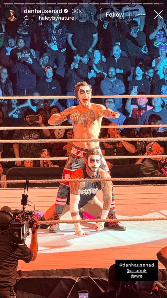 CM Punk in Danhausen-style face paint kneels in the ring as Danhausen poses behind him at a WWE live event in Winnipeg