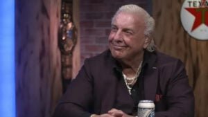 Ric Flair smiling while seated during a TV interview