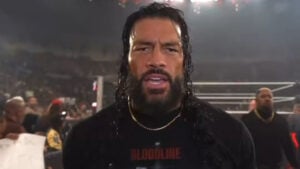 Roman Reigns in a Bloodline shirt at ringside after WWE Raw